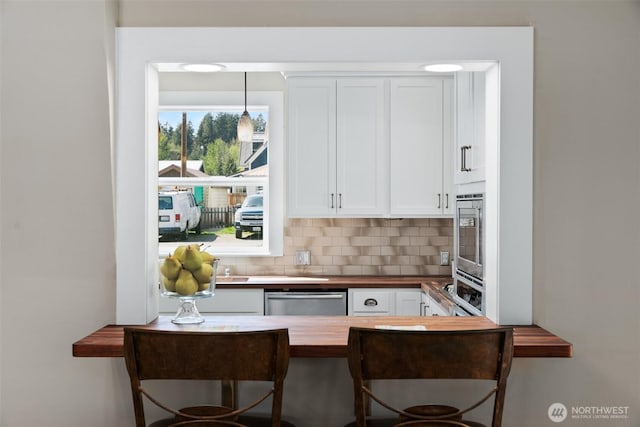 209 W 3rd St, Cle Elum, WA 98922 - kitchen featuring butcher block countertops, decorative backsplash, dishwasher, and white cabinets