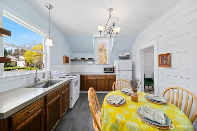 209 W 3rd St, Cle Elum, WA 98922 - kitchen with open shelves, vaulted ceiling, a sink, a notable chandelier, and white appliances