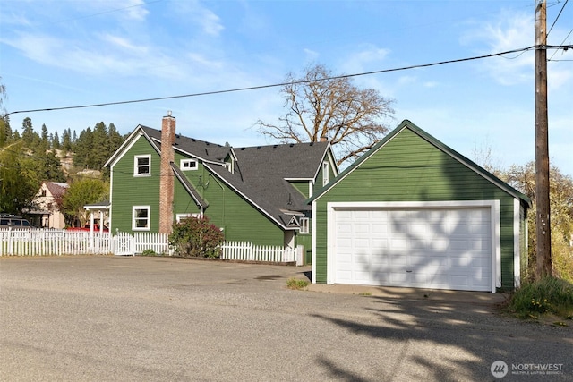 209 W 3rd St, Cle Elum, WA 98922 - view of front facade with fence, a chimney, and a garage