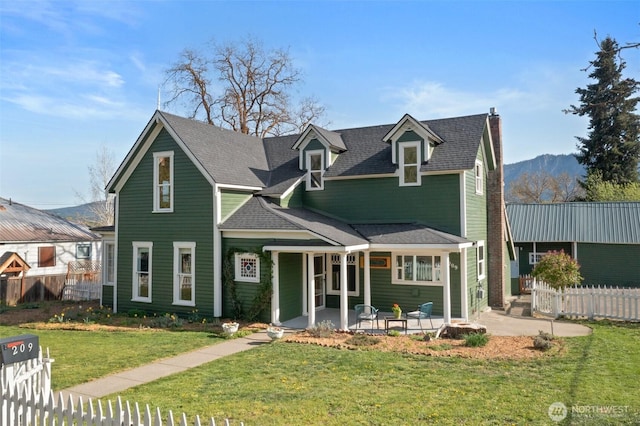 209 W 3rd St, Cle Elum, WA 98922 - view of front of home featuring fence, a chimney, a patio area, and a front lawn