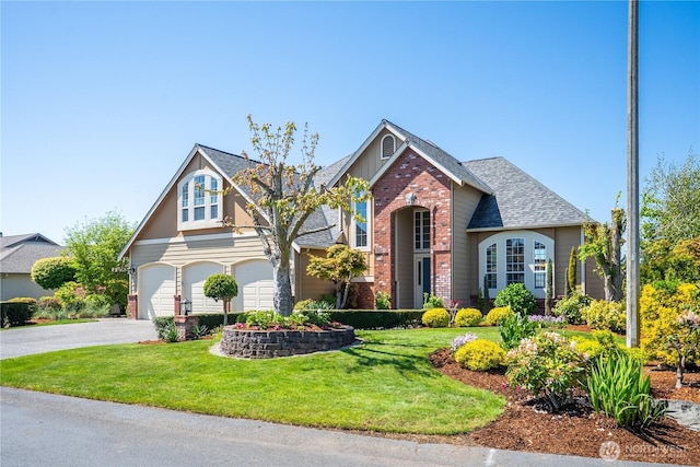 craftsman-style house with a garage, aphalt driveway, a front yard, roof with shingles, and brick siding