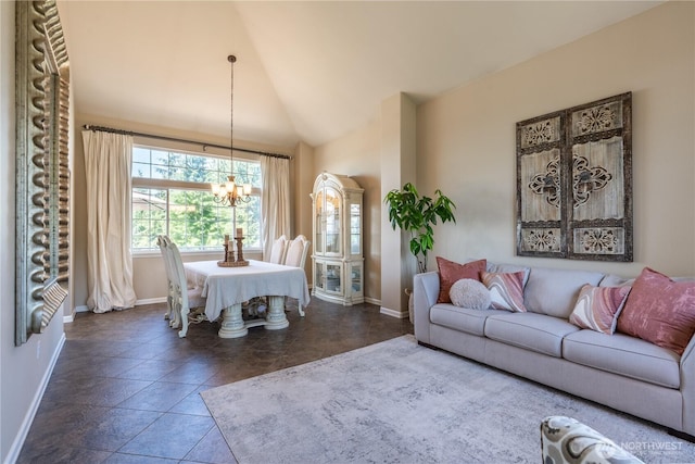 living area with baseboards, a notable chandelier, and high vaulted ceiling