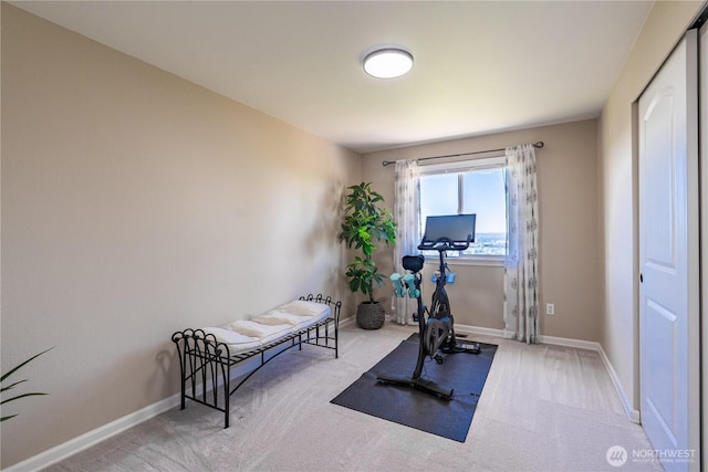 workout room featuring carpet floors and baseboards