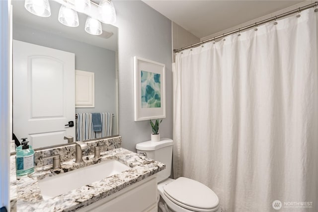full bathroom featuring toilet and vanity