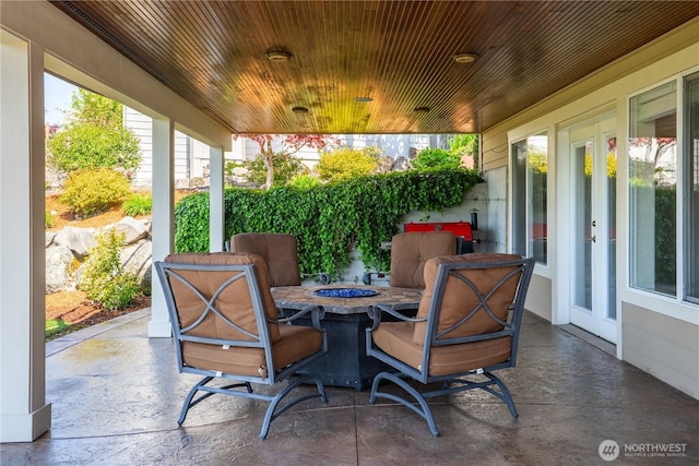 view of patio with french doors and an outdoor fire pit