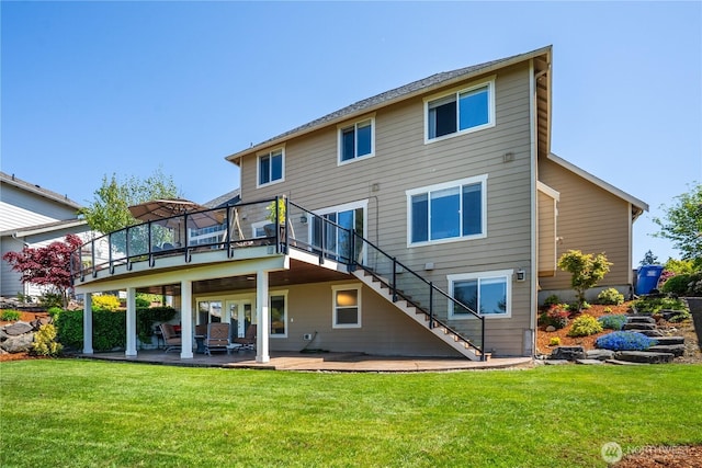 back of house featuring stairs, a lawn, and a deck