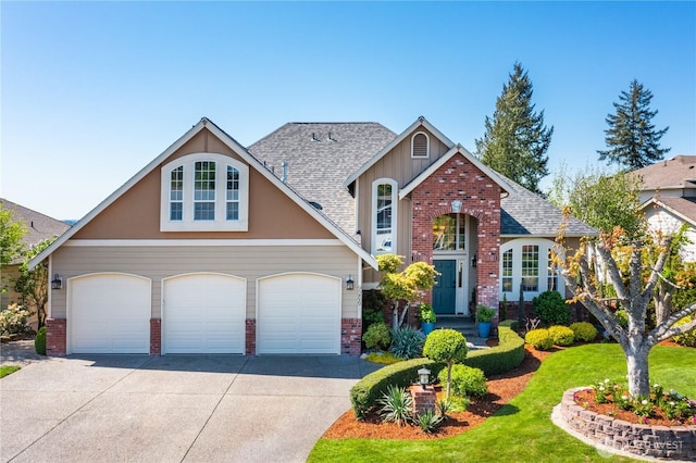traditional-style home with a garage, a front yard, roof with shingles, brick siding, and driveway