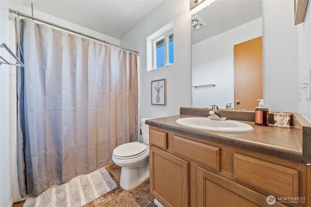 bathroom with toilet, curtained shower, and vanity