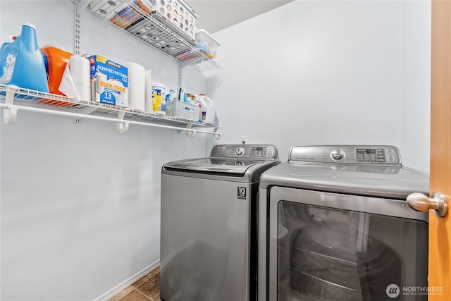 clothes washing area with laundry area and washer and clothes dryer