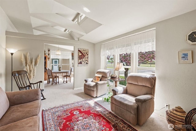 living area with baseboards, carpet, a chandelier, and vaulted ceiling