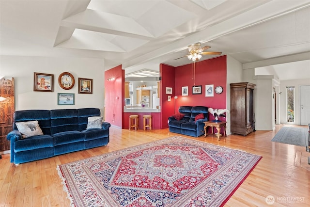 living room featuring ceiling fan, vaulted ceiling, and wood finished floors