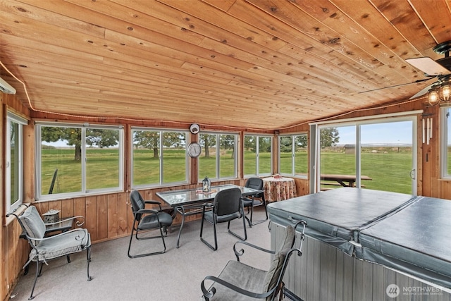 sunroom with a ceiling fan and a hot tub