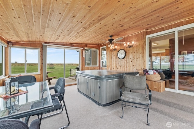sunroom / solarium with ceiling fan and a hot tub