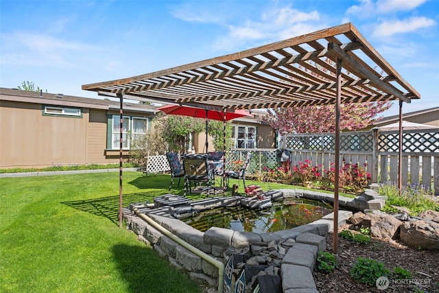 view of yard with a small pond, a pergola, and fence