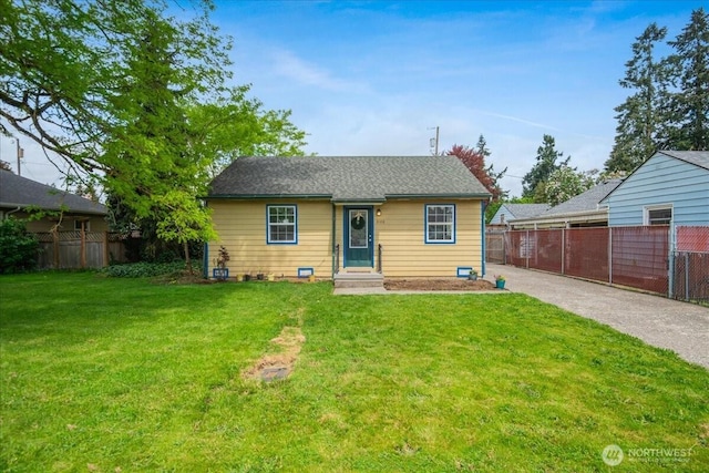 back of house featuring a yard and fence
