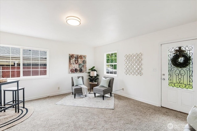 carpeted foyer entrance with baseboards