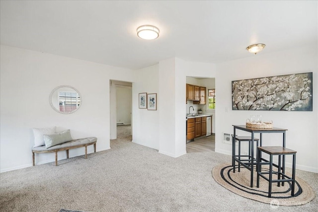 dining room featuring baseboards and light colored carpet