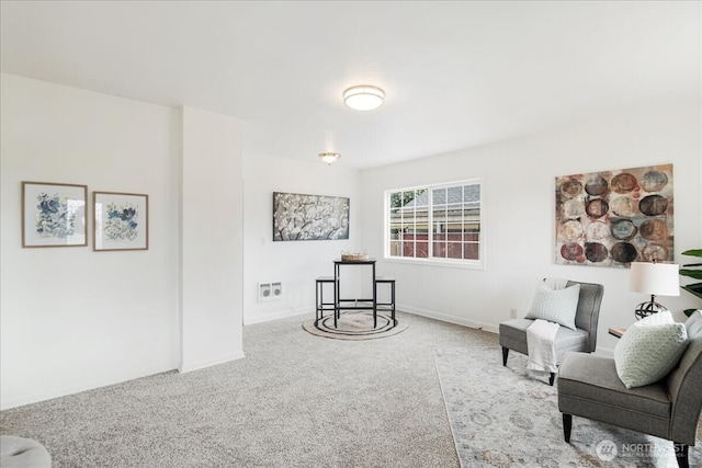 sitting room with baseboards and carpet