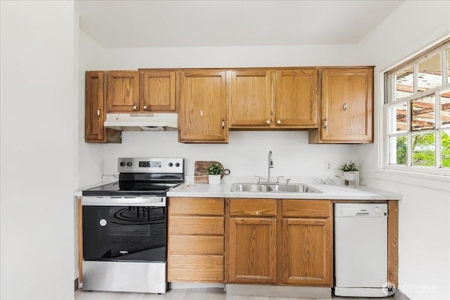kitchen featuring white dishwasher, light countertops, under cabinet range hood, stainless steel electric stove, and a sink