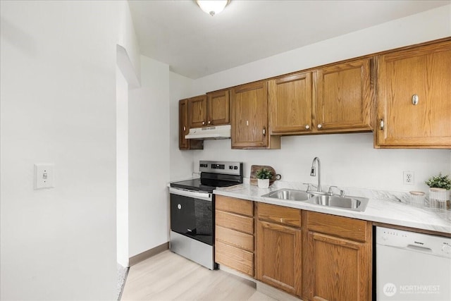 kitchen with white dishwasher, light countertops, a sink, stainless steel electric stove, and under cabinet range hood