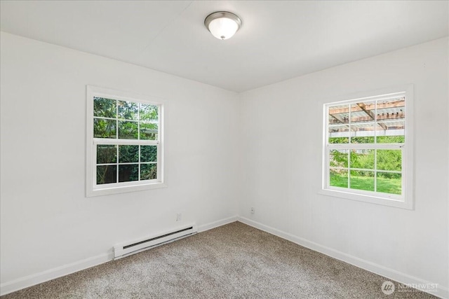 carpeted empty room featuring baseboards and a baseboard heating unit