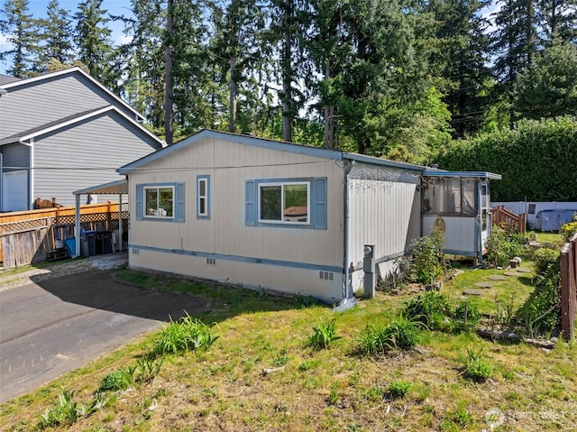 view of home's exterior featuring fence and crawl space
