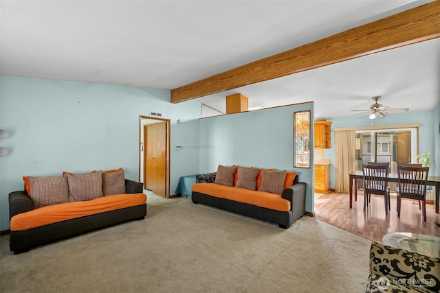 living area featuring ceiling fan, carpet, beam ceiling, and visible vents