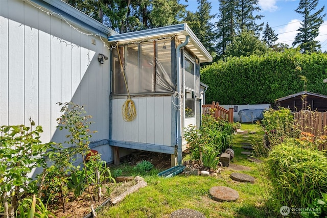view of side of property featuring fence