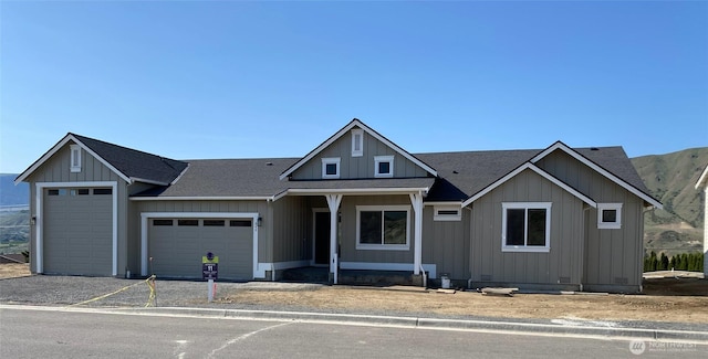 view of front of property featuring a garage, board and batten siding, driveway, and a shingled roof