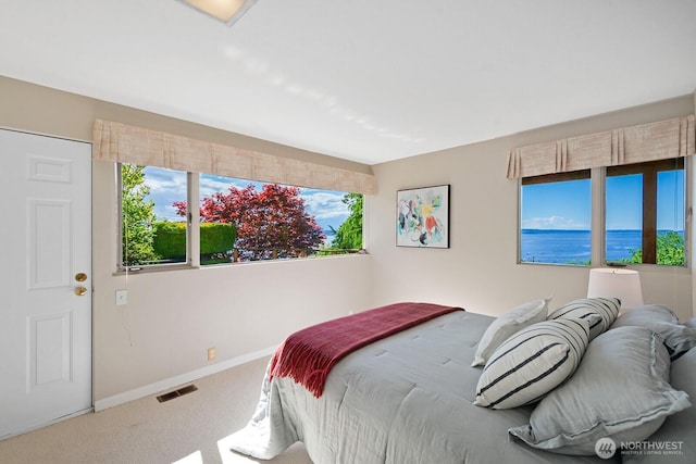 carpeted bedroom featuring baseboards