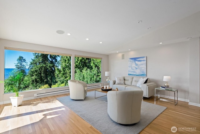 living room featuring baseboard heating, wood finished floors, recessed lighting, baseboards, and lofted ceiling