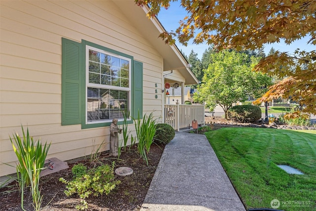 view of exterior entry featuring a yard