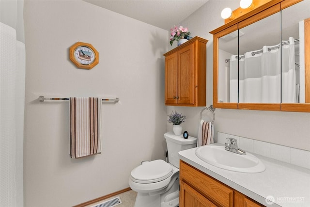 bathroom with vanity, a shower with curtain, and toilet