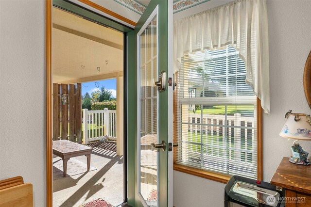 entryway featuring french doors and a textured wall