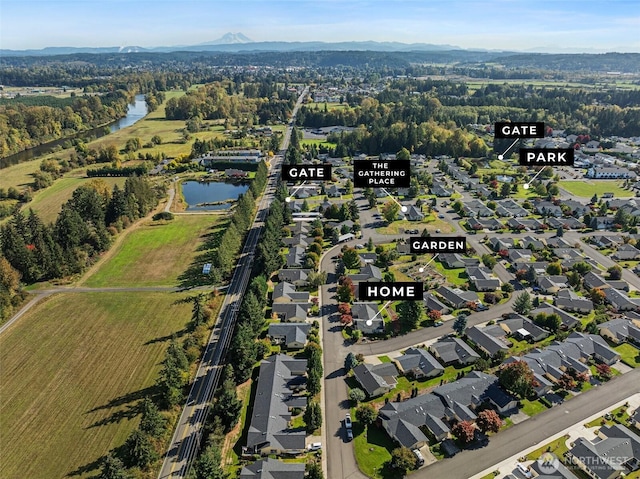 birds eye view of property featuring a residential view and a water and mountain view