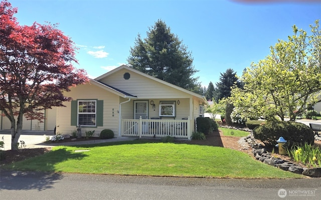bungalow with covered porch and a front lawn