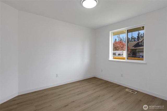 22516 45th Ave E, Spanaway, WA 98387 - empty room featuring baseboards, visible vents, and wood finished floors