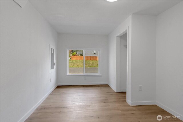 22516 45th Ave E, Spanaway, WA 98387 - empty room featuring baseboards, electric panel, and light wood finished floors
