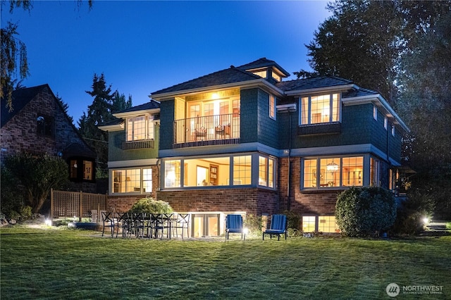 8314 Island Dr S, Seattle, WA 98118 - back of house with a yard, brick siding, and a balcony