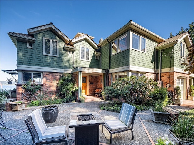 8314 Island Dr S, Seattle, WA 98118 - back of house with a patio, a fire pit, and brick siding