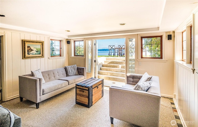 8314 Island Dr S, Seattle, WA 98118 - living room featuring a water view, a healthy amount of sunlight, and a decorative wall