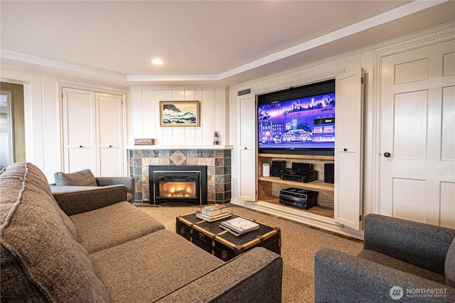 8314 Island Dr S, Seattle, WA 98118 - living room featuring a tiled fireplace, carpet floors, a decorative wall, and recessed lighting