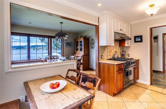 8314 Island Dr S, Seattle, WA 98118 - kitchen with white cabinets, an inviting chandelier, high end stove, decorative backsplash, and under cabinet range hood