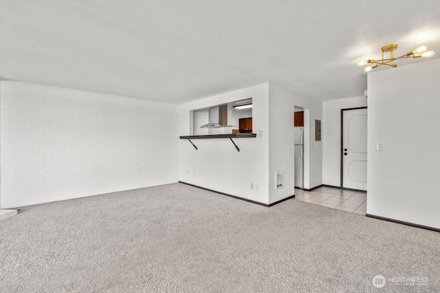 9500 Rainier Ave S Unit 102, Seattle, WA 98118 - unfurnished living room with visible vents, carpet flooring, baseboards, and electric panel