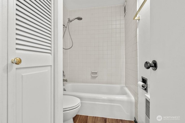 9500 Rainier Ave S Unit 102, Seattle, WA 98118 - bathroom with toilet, washtub / shower combination, and wood finished floors