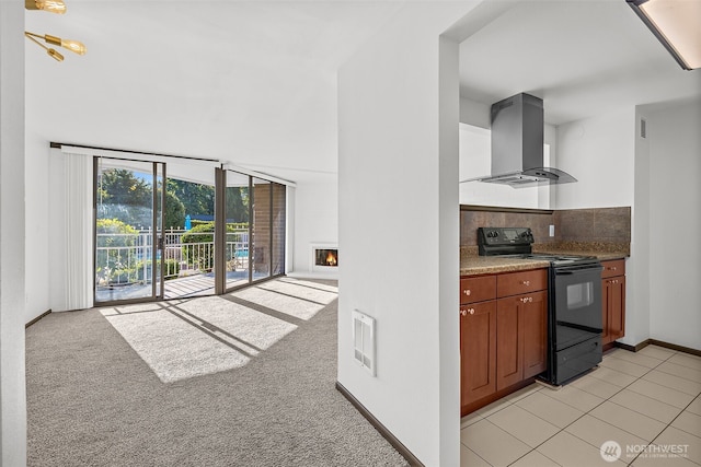 9500 Rainier Ave S Unit 102, Seattle, WA 98118 - kitchen featuring exhaust hood, electric range, a high ceiling, tasteful backsplash, and visible vents