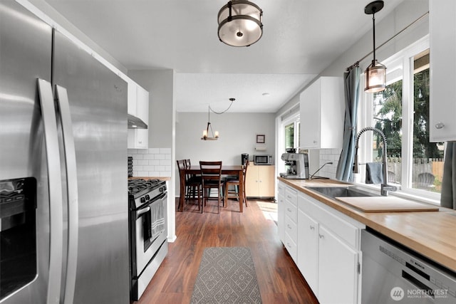 1718 33rd St SE, Auburn, WA 98002 - kitchen featuring appliances with stainless steel finishes, a sink, backsplash, and white cabinets