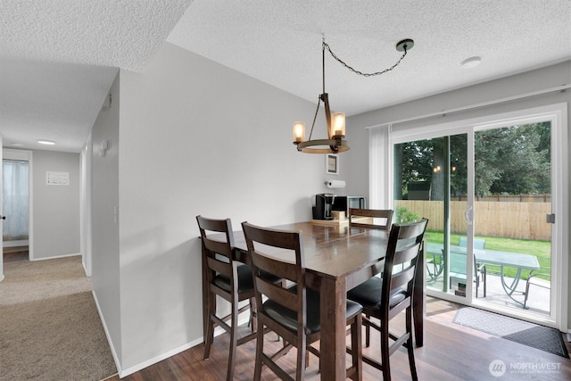 1718 33rd St SE, Auburn, WA 98002 - dining space with a textured ceiling, baseboards, wood finished floors, and a chandelier