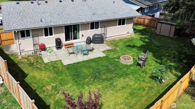1718 33rd St SE, Auburn, WA 98002 - rear view of house with a fire pit, a storage shed, a patio, a shingled roof, and an outbuilding