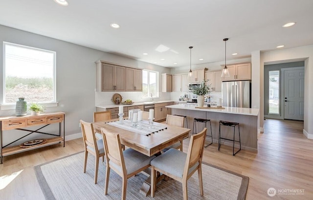 dining space featuring recessed lighting, baseboards, and light wood finished floors